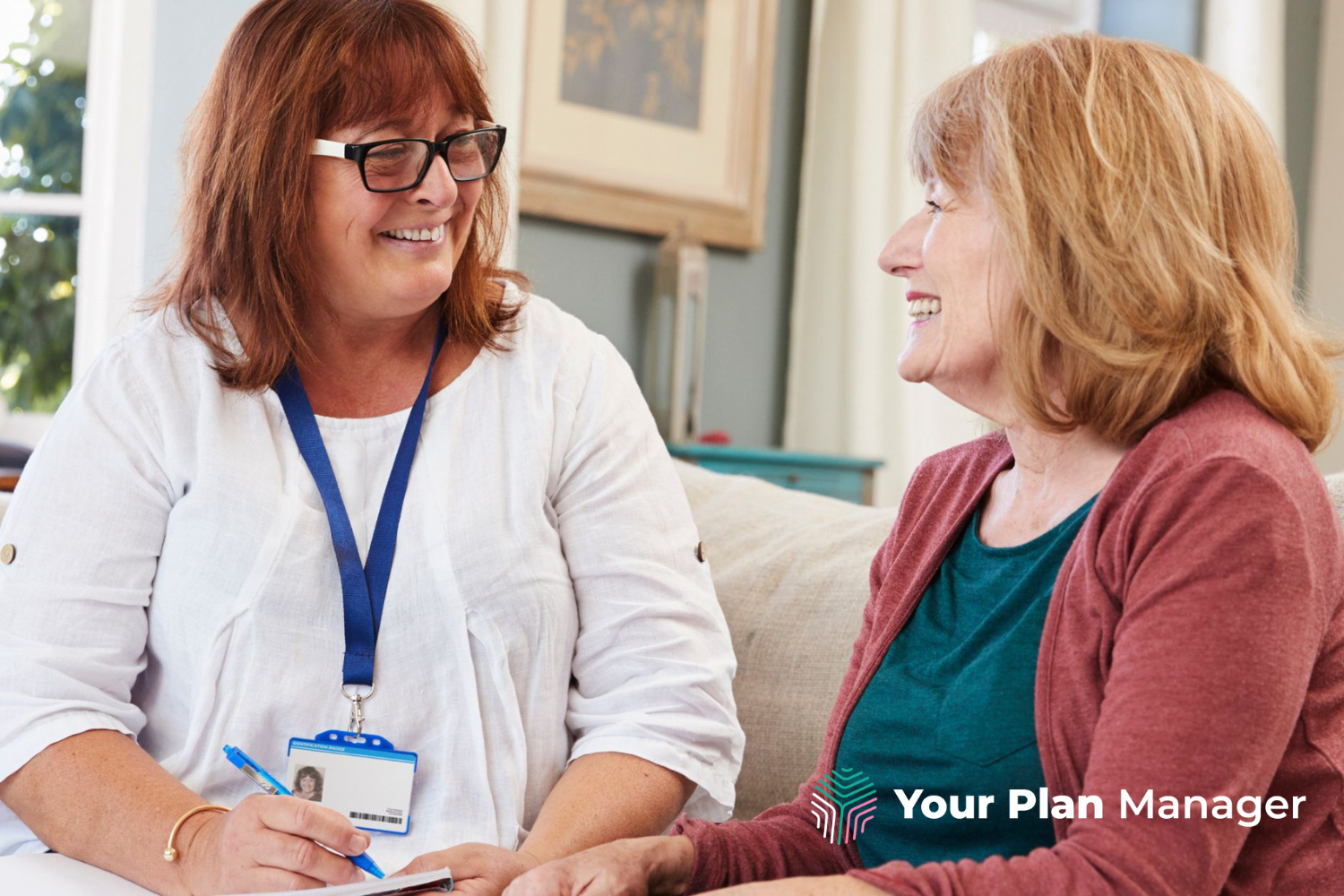 Two women talking together on a couch discussing an NDIS Plan