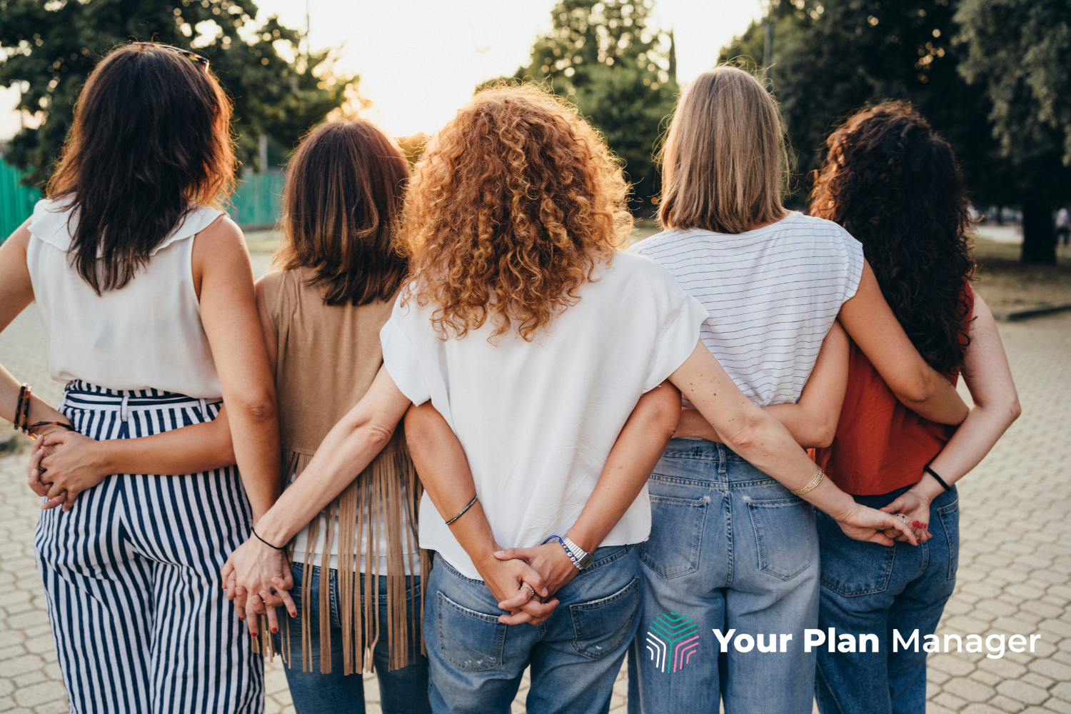 five women stand together